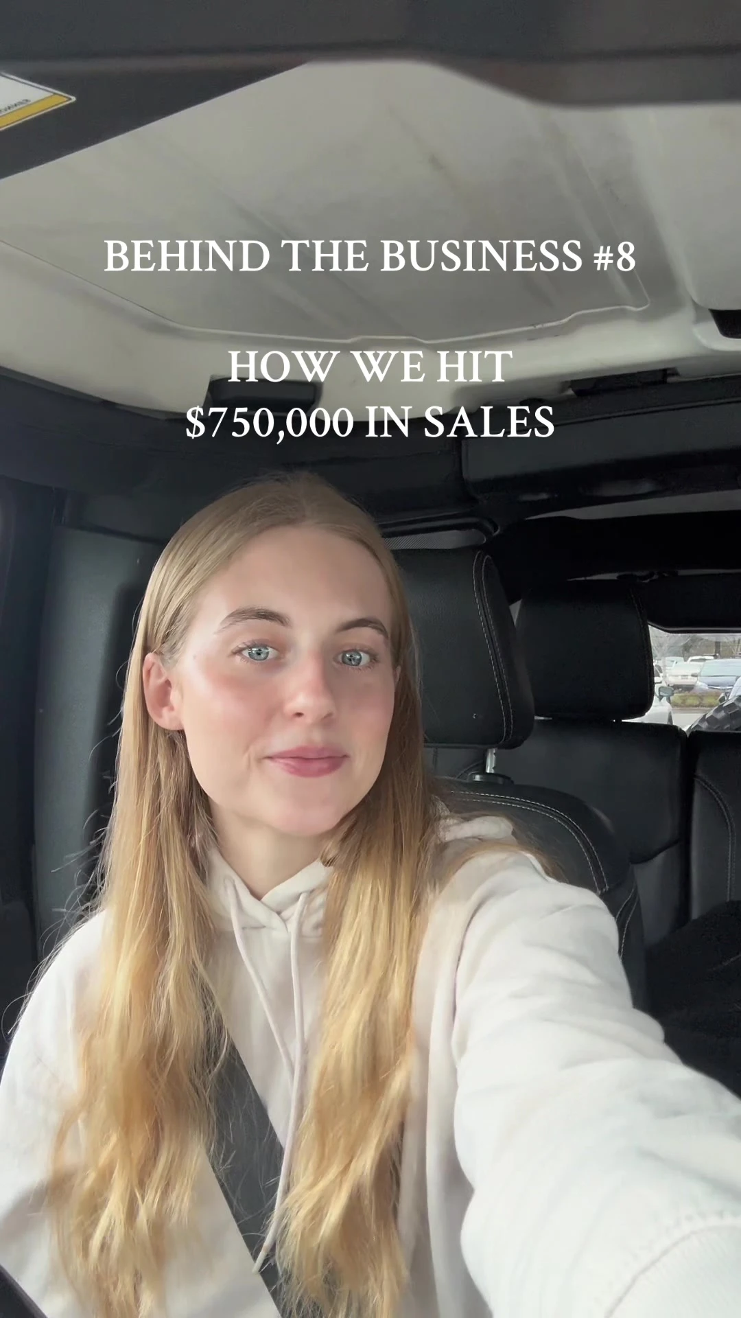 A founder in a car introducing a Behind the Business video about reaching $750,000 in sales