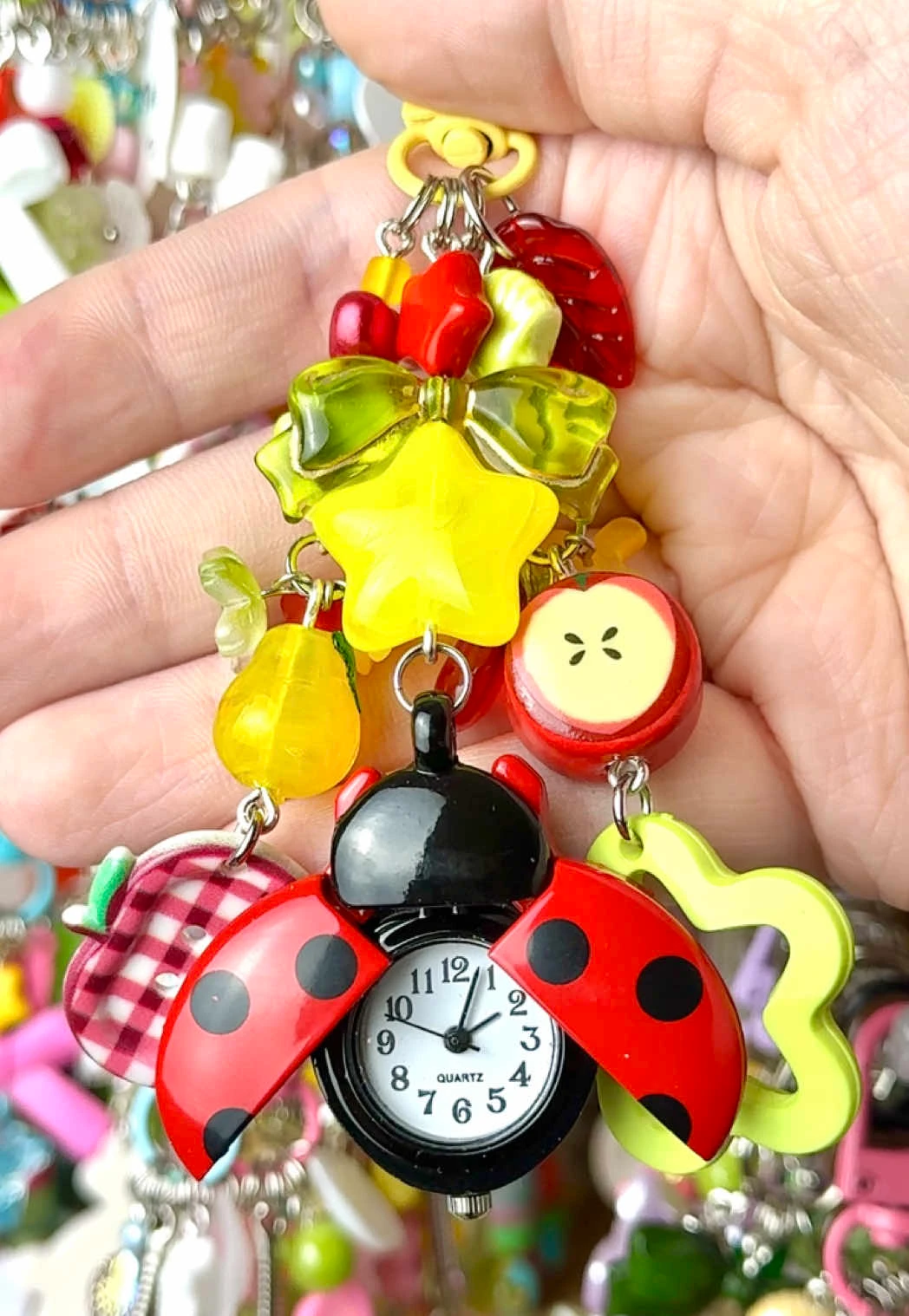 A close-up of colorful charms being packed for a small-business order